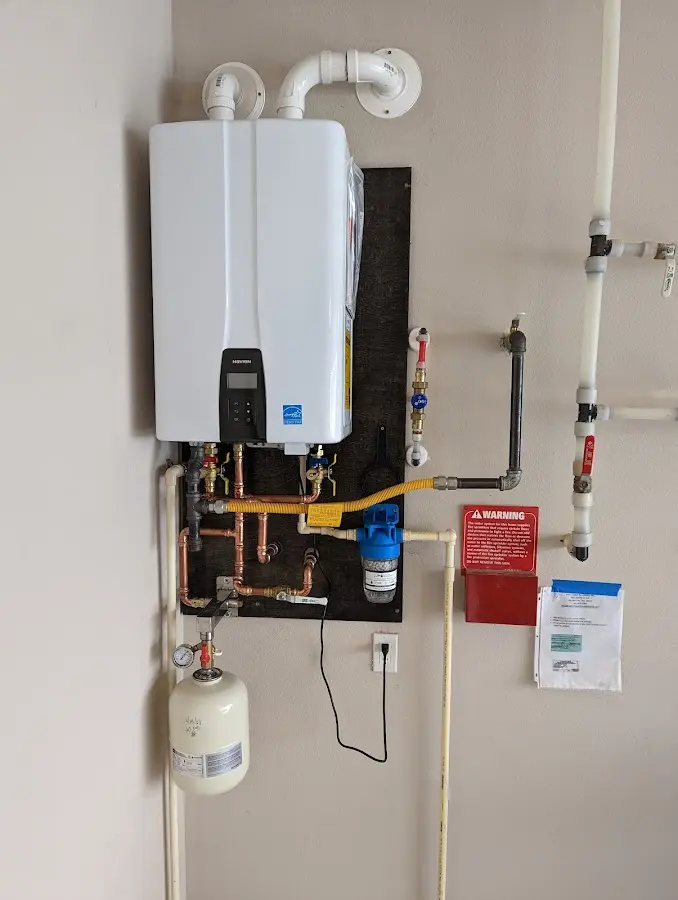 Professional plumber installing copper piping in a National Harbor home